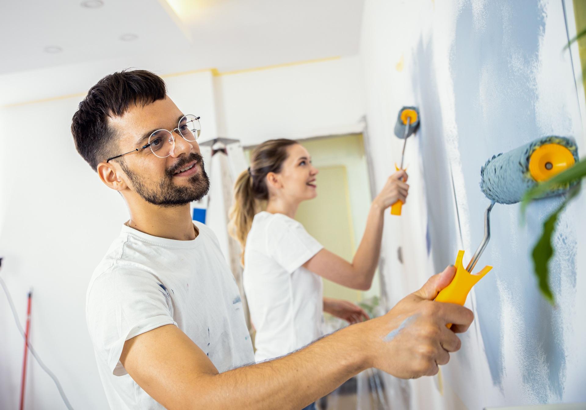 Zwei Personen streichen gemeinsam eine Wand | Duschrückwand